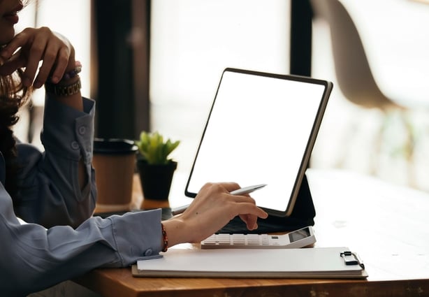 Woman making notes while working from home