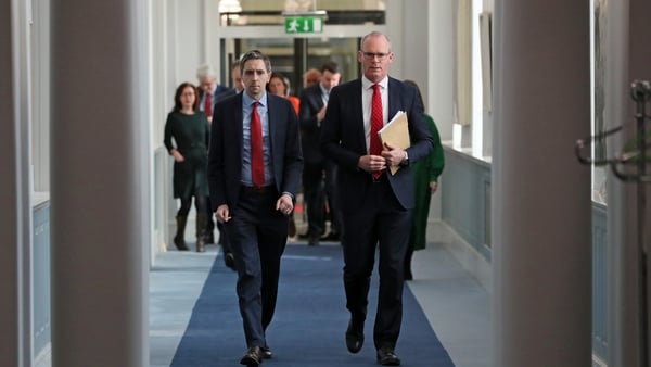 Fine Gael leader Simon Harris, left, was quick to speak highly of Simon Coveney after he announced his departure from Cabinet (file photo)