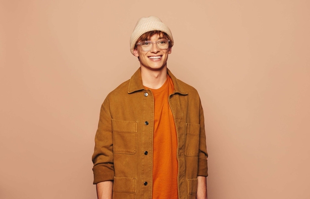 Man wearing an orange t-shirt and jacket