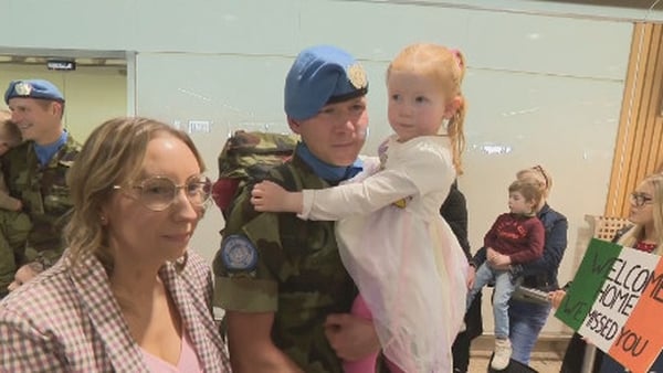 Private Neil McManus reunited with his wife Lisa and daughter Lucy at Dublin Airport