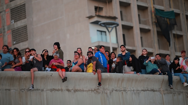 People take photos of the sun setting in Mazatlan, Mexico, yesterday ahead of this evening's eclipse