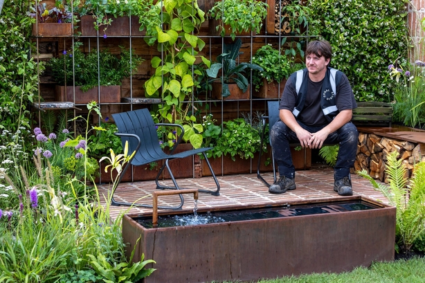 Designer Conal McGuire in his gold medal-winning RHS Flower Show garden 'Brickyard' at Tatton Park in 2023 (Neil Hepworth/RHS/PA)