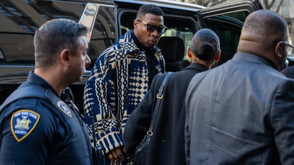 Jonathan Majors (centre) arriving for sentencing at Manhattan Criminal Court in New York on Monday