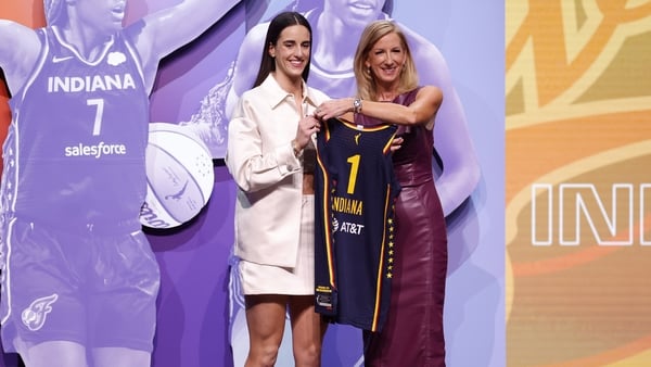 Caitlin Clark poses with WNBA commissioner Cathy Engelbert after being selected first overall in the draft