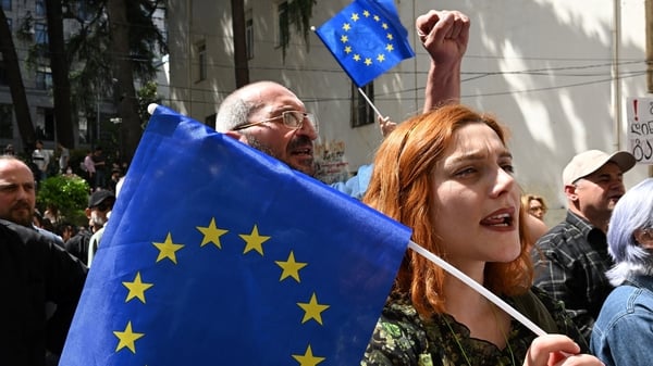 Demonstrators hold European flags as they protest against a draft bill on 'foreign influence outside the parliament building in Tbilisi