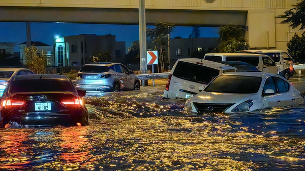 Cars drive in a flooded street following heavy rains in Dubai