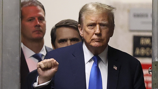 Former US President Donald Trump gestures while he returns to the courtroom for his trial