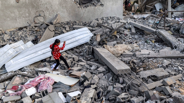 A girl walks through rubble in Rafah in the southern Gaza