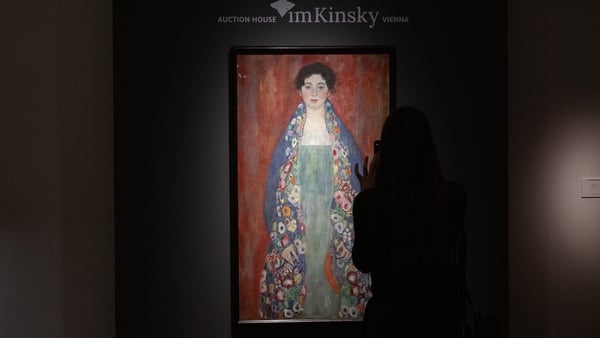 A visitor takes a picture of the rediscovered painting of a young female 'Portrait of Miss Lieser' by the Austrian painter Gustav Klimt
