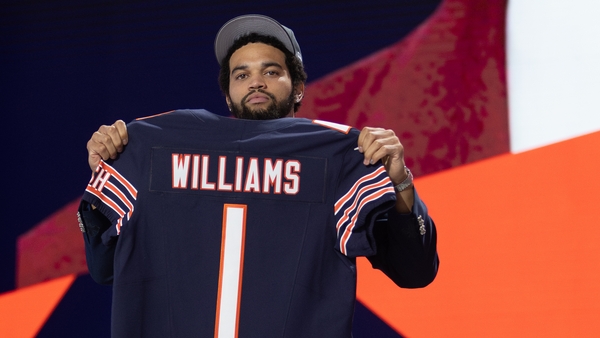 Quarterback Caleb Williams poses with his Chicago Bears jersey