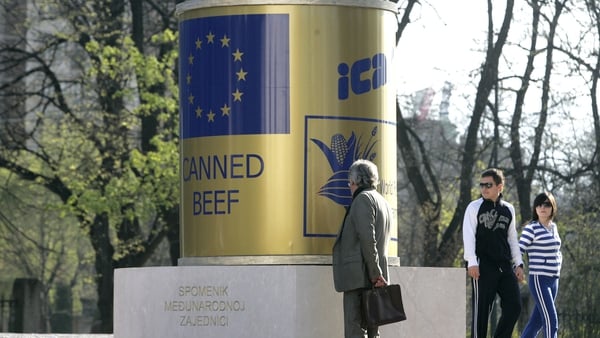Residents of Sarajevo pass by the canned beef monument in 2007