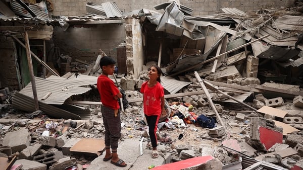 Children in the rubble of a house in Rafah, Gaza, following Israeli bombardment