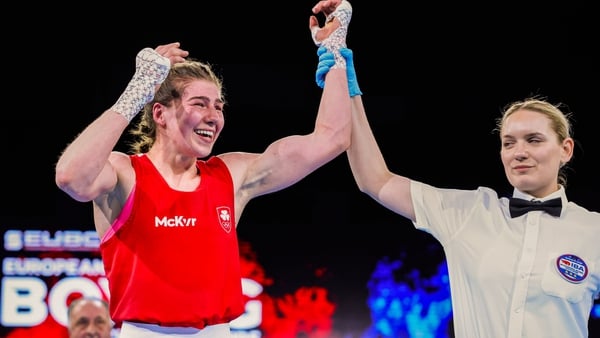 Aoife O'Rourke has her hand raised in victory following a bruising battle en route to gold