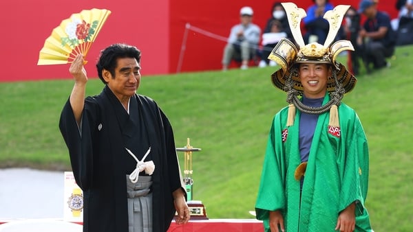 Yuto Katsuragawa (r) celebrates victory alongside Dr. Haruhisa Handa, Chairman of ISPS during the trophy presentation after winning the tournament