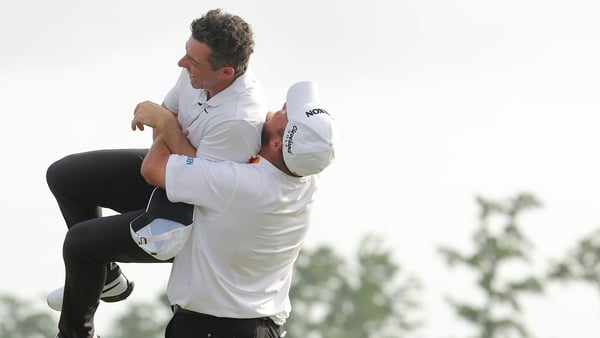 Rory McIlroy and Shane Lowry celebrate after securing the victory on the first play-off hole