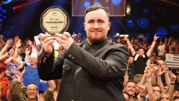 Luke Littler dons the Austrian Open's Green Jacket and celebrates in front of the fans in Gratz after defeating Joe Cullen in the final