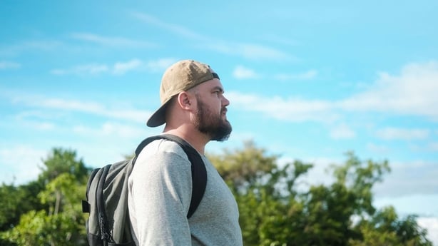 Man out walking on a sunny day with a backpack