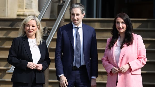 Simon Harris (C)was greeted by Michelle O'Neill (L) and Emma Little-Pengelly (R) upon his arrival