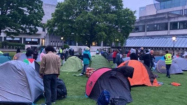 Students have pitched 15 tents on the grass near the entrance to the Book of Kells Experience