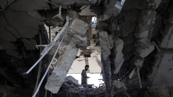 A Palestinian man stands amid the rubble of a building destroyed by Israeli bombing in Rafah in southern Gaza
