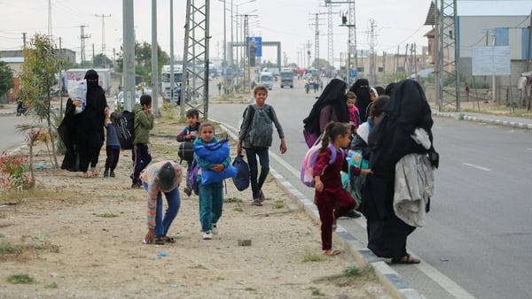 Displaced Palestinians in Rafah await transportation following an evacuation order