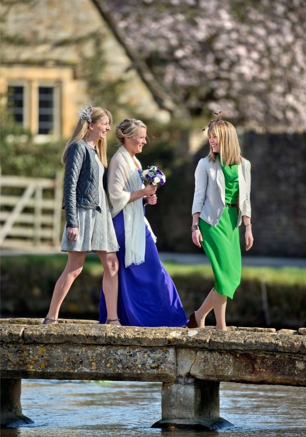 Three wedding guests in dresses