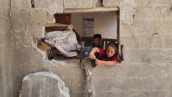 Palestinian children are seen inside destroyed houses after Israeli attacks in Rafah