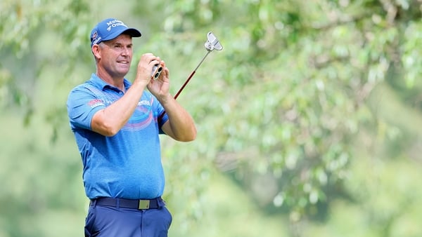 Padraig Harrington of Ireland checks the yardage on the second tee