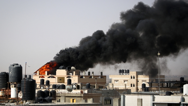Thick, black smoke rises from a fire in a building caused by Israeli bombardment in Rafah