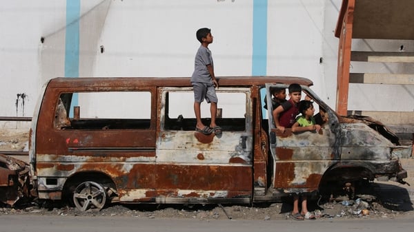 Children play in a charred van in Rafah in southern Gaza