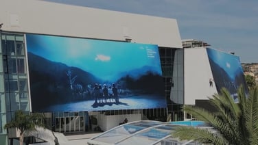 The official poster of the 77th Festival de Cannes is raised above Palais des Festivals