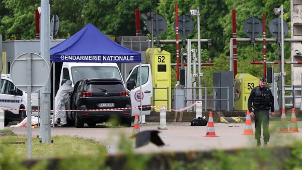 Police officers examine the scene at the tollbooth in Incarville in France