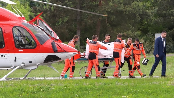 Robert Fico is transported from a helicopter by medics and his security detail to the hospital in Banska Bystrica