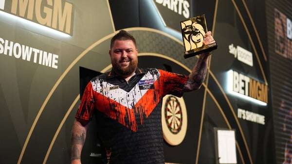 Michael Smith with the trophy after victory during the final against Luke Humphries