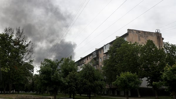 Smoke rises from behind an apartment block after shelling by Russian troops in Kharkiv