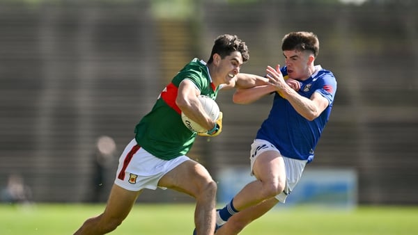 Mayo's Tommy Conroy (L) tries to power past Cavan's Cian Reilly