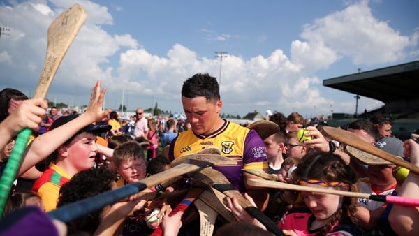 Wexford's Lee Chin, who finished with 0-13, signs autographs for supporters after victory over Carlow