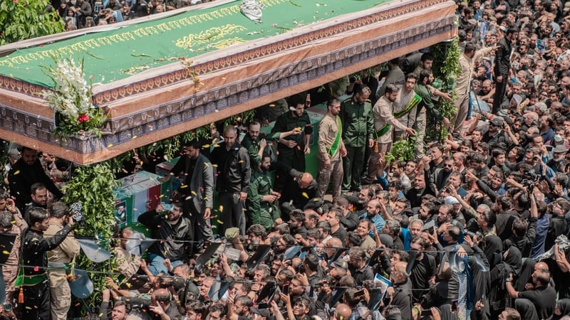 Mourners attend the funeral procession of President Ebrahim Raisi in Tehran