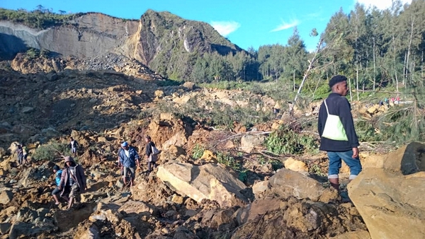 People gather at the site of a landslide in Maip Mulitaka in Papua New Guinea's Enga Province