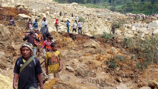 Locals gather at the site of a landslide at Mulitaka village in the region of Maip Mulitaka, in Papua New Guinea's Enga Province