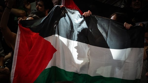 Demonstrators holding a Palestinian flag at a protest against Israel's war in Gaza
