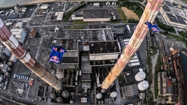 Watch: Skydivers fly though Dublin's Poolbeg Chimneys at sunrise