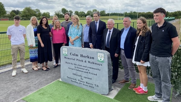 Taoiseach Simon Harris, centre, and Minister for Justice Helen McEntee at the official opening of the Colm Horkan Memorial Pitch and Community Walkways