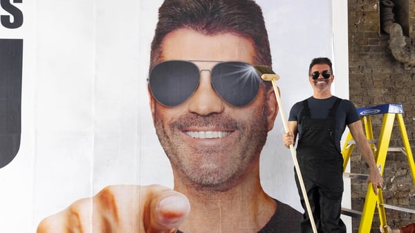 Simon Cowell 'installs' a billboard in London as he launches his UK and Ireland search for the next 'boyband sensation'