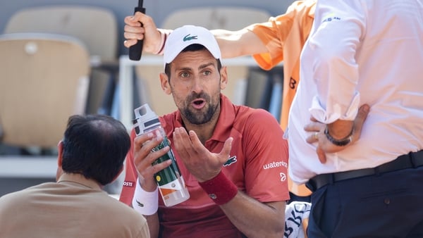 Novak Djokovic receives treatment for his knee injury during his match against Francisco Cerundolo