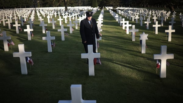 A visitor pays his respects at the Normandy American Cemetery above Omaha Beach today