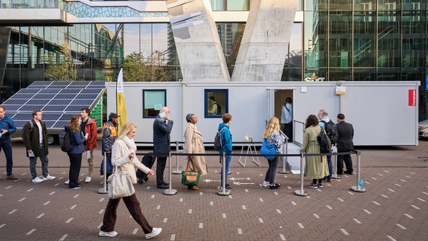 Voters queue to vote outside a polling station in The Hague in the Netherlands