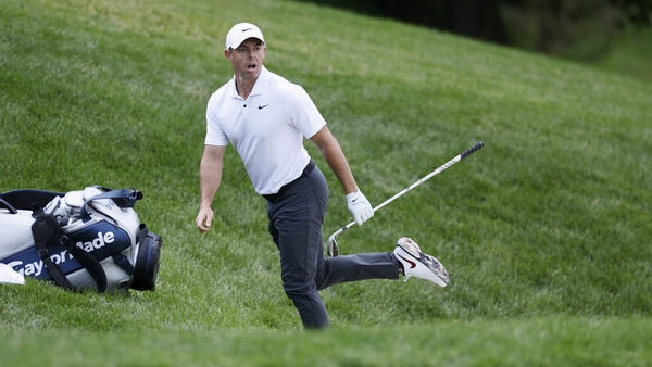 McIlroy reacts after nearly holing out from the bunker at the 17th hole