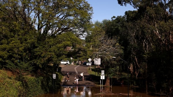 People observe the floodwaters along the Hawkesbury River