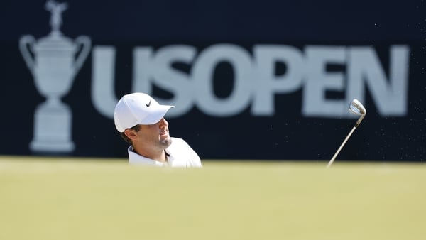 Scottie Scheffler chips onto the third green during a practice round on Wednesday